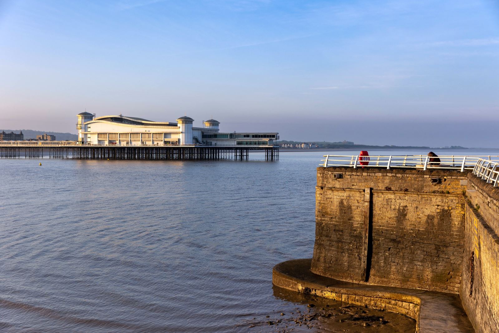 View of the edge of the harbour wall at Knightstone Island, Weston-super-Mare and the Grand Pier with the sea in between